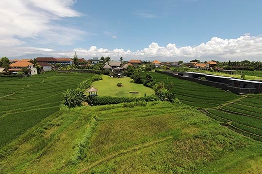 Aerial of villa and surrounding paddyfields